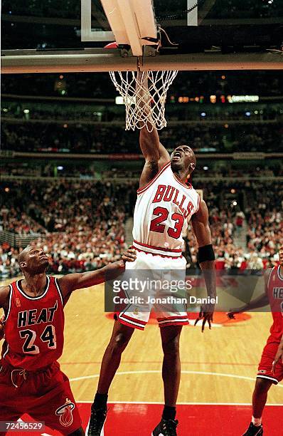 Michael Jordan of the Chicago Bulls dunks the ball during the game against the Miami Heat at the United Center in Chicago, Illinois. The Bulls...