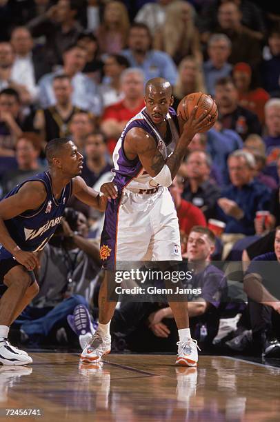 Point guard Stephon Marbury of the Phoenix Suns posts up guard Chris Whitney of the Washington Wizards during the NBA game at the American Airlines...