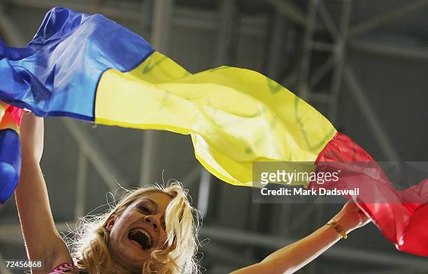 Romanian fan waves a flag in celebration after her team won the gold medal in the women's artistic gymnastics team final competition on August 17,...