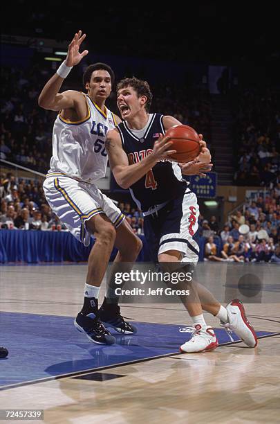 Forward Luke Walton of the Arizona Wildcats goes to the basket as center Dan Gadzuric of the UCLA Bruins plays defense during the Pac-10 game at the...