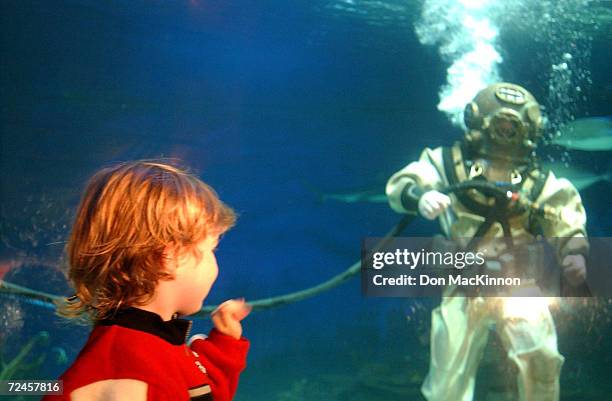 Diver Bob Crawaford, in a 1950's Mark-5 dive suit, waves to 4-year-old Jack Craddock during the kick off of Diver's Weekend at the Vancouver Aquarium...