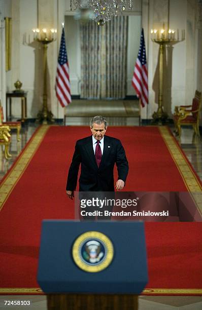 President George W. Bush walks through the Cross Hall to a press conference in the East Room of the White House November 8, 2006 in Washington, DC....