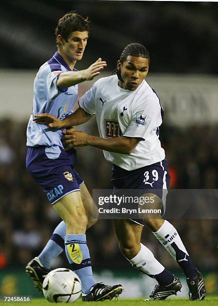 Andy Barcham of Tottenham Hotspur collides with George Pilkington of Port Vale during the Carling Cup Fourth Round match between Tottenham Hotspur...