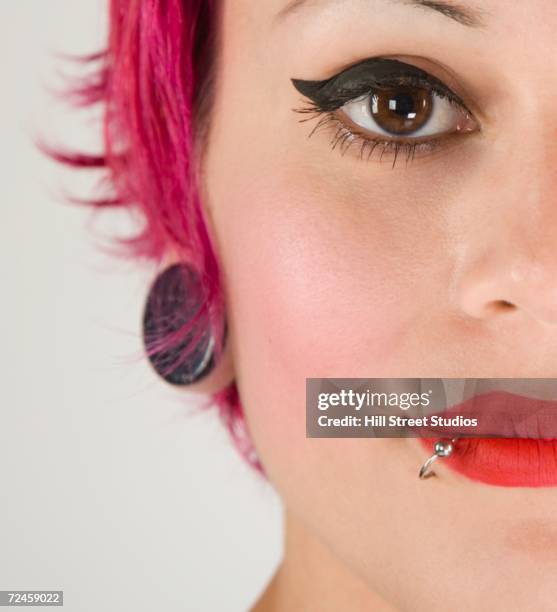 close up of woman's face with lip piercing - pierced stock pictures, royalty-free photos & images