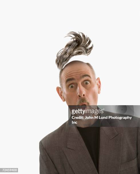 studio shot of man with toupee floating above head - perücke stock-fotos und bilder