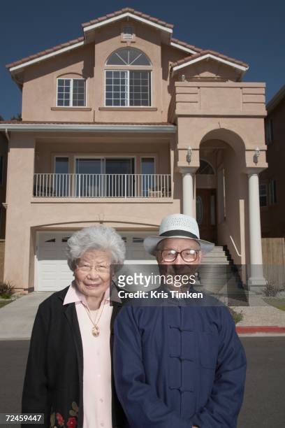 senior asian couple in front of house - daly city stock pictures, royalty-free photos & images