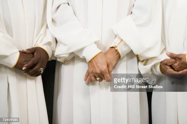 close up of senior women in choir gowns with hands clasped - manto de cerimônia - fotografias e filmes do acervo