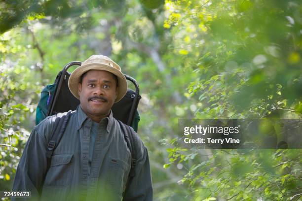 african man wearing backpack in woods - terry woods stock pictures, royalty-free photos & images