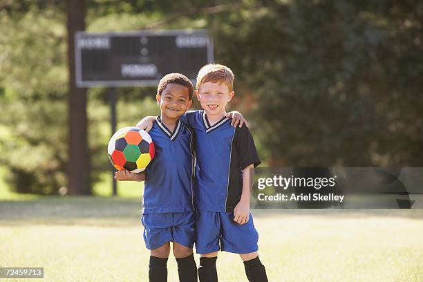 two young boys in soccer gear with ball - boy freckle stock pictures, royalty-free photos & images