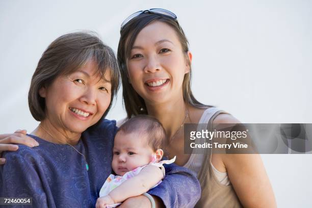 asian grandmother with mother and baby smiling - grootmoeder witte achtergrond stockfoto's en -beelden