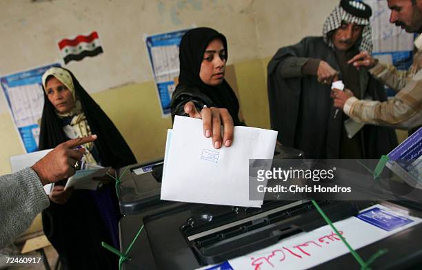 Voters place ballots into sealed boxes on Election Day in the Sadr City neighborhood of Baghdad January 30, 2005 in Baghdad, Iraq. Iraq 's first...
