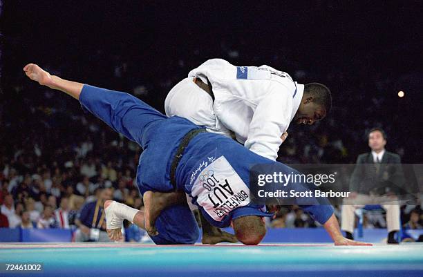 Ato Hano of the USA flips his opponent, Franz Birkfellner of Austria during the Men's 100 kg judo match at the Sydney Olympic Games in Sydney,...