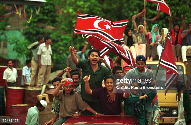 Supporters of the Free Aceh Movement celebrate the 23rd anniversary of their independence movement December 7, 1999 in Indonesia's northernmost...