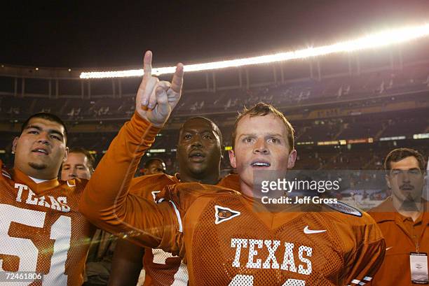 Quarterback Major Applewhite of Texas and teammates celebrate after the Holiday Bowl game against Washington at Qualcomm Stadium in San Diego,...