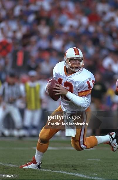 Quarterback Trent Dilfer of the Tampa Bay Buccaneers drops back to pass as he scans the defense for an open receiver during a pass play in the...