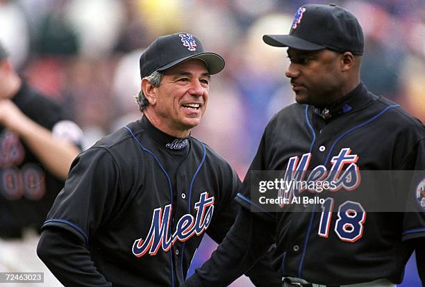 Manager Bobby Valentine of the New York Mets shakes hands with Darryl Hamilton and congratulates him during the game against the San Diego Padres at...