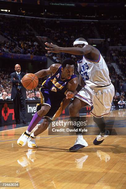 Guard Kobe Bryant of the Los Angeles Lakers dribbles the ball around forward Jumaine Jones of the Cleveland Cavaliers during the NBA game at the Gund...