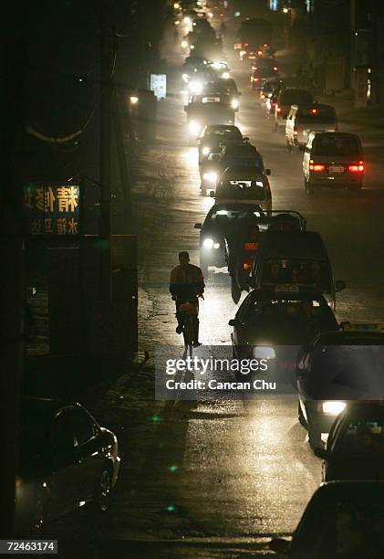 Crs crowd a road November 17, 2004 in Beijing, China. With people buying more cars, traffic jams in Beijing continue to be a major problem, despite...