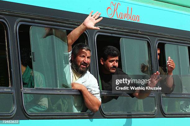 Freed Iraqi prisoners waves from a bus after being released from Abu Ghraib prison May 21, 2004 outside of Baghdad, Iraq. More than 400 prisoners...