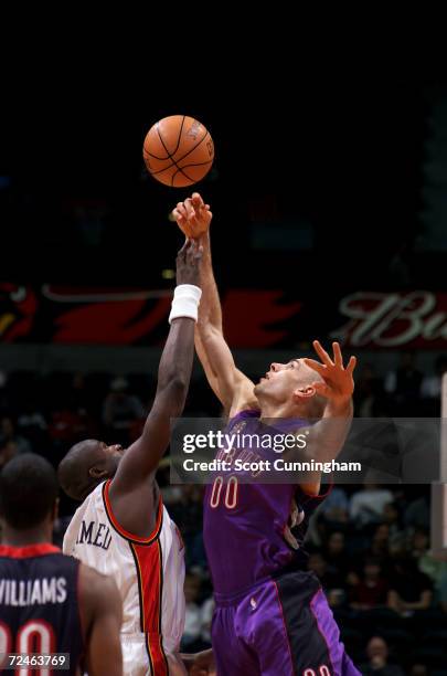 Eric Montross of the Toronto Raptors and Nazr Mohammed of the Atlanta Hawks jump for the opening tip off at Philips Arena in Atlanta, Georgia....