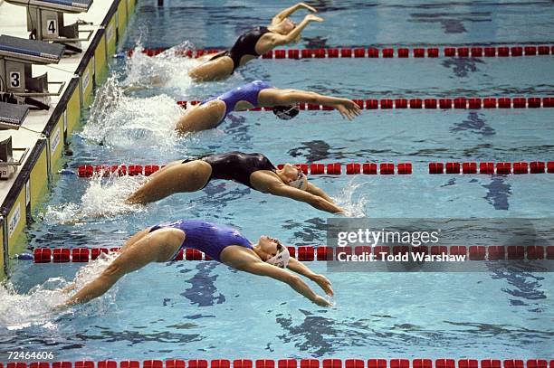 The line-up starting from bottom: Lea Maurer , Antje Buschschulte , Jamie Reid and Anke Scholz as they dive at the start of the 100 Backstroke during...