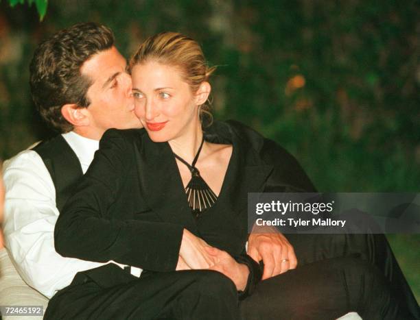 John F. Kennedy, Jr. Editor of George magazine, gives his wife Carolyn a kiss on the cheek during the annual White House Correspondents dinner May 1,...