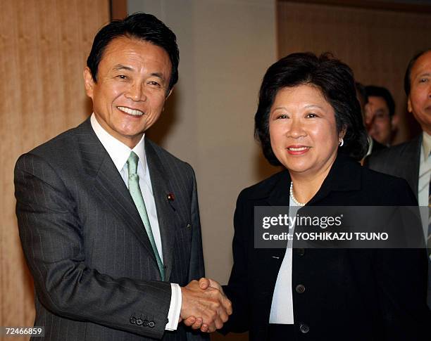 Indonesian Trade Minister Mari Elka Pangetsu shakes hands with Japanese Foreign Minister Taro Aso prior to their talks at Aso's office in Tokyo, 09...