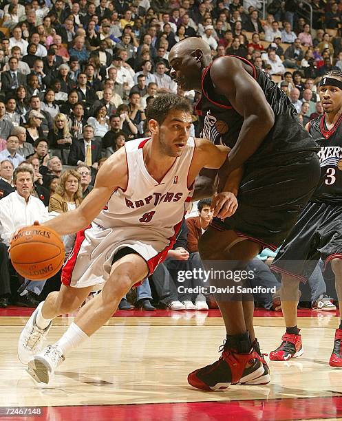 Jose Calderon of the Toronto Raptors drives to the basket as Chris Webber of the Philadelphia 76ers defends on November 8, 2006 at the Air Canada...