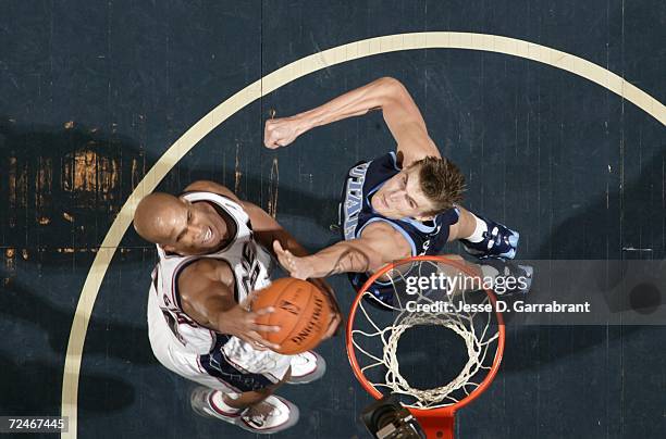 Richard Jefferson of the New Jersey Nets shoots against Andrei Kirilenko of the Utah Jazz on November 8, 2006 at Continental Airlines Arena in East...