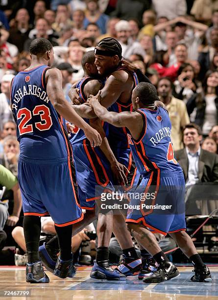 Jamal Crawford of the New York Knicks is swarmed by teammates Eddy Curry, Nate Robinson and Quentin Richardson after he scored the game winning 3...