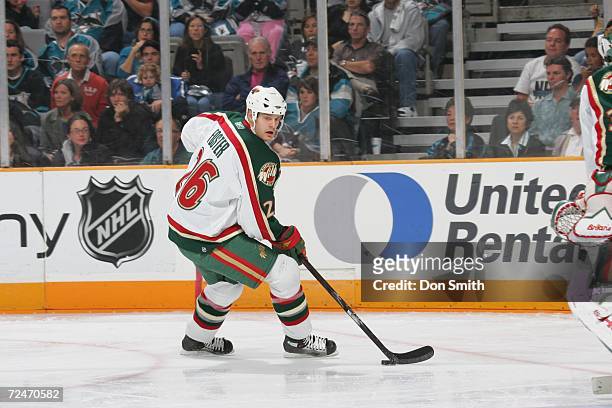 Kurtis Foster of the Minnesota Wild skates with the puck during a game against the San Jose Sharks on October 21, 2006 at the HP Pavilion in San...