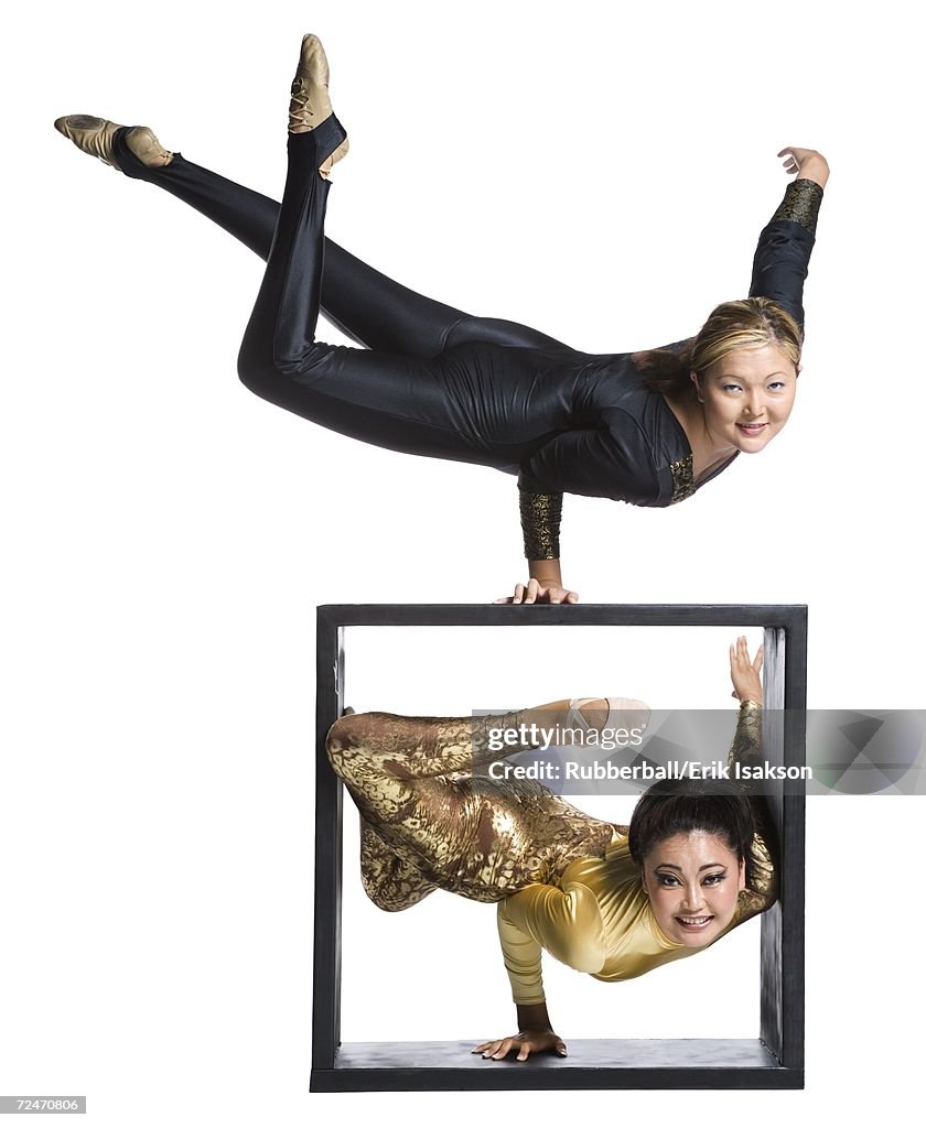 Female contortionist duo with box prop