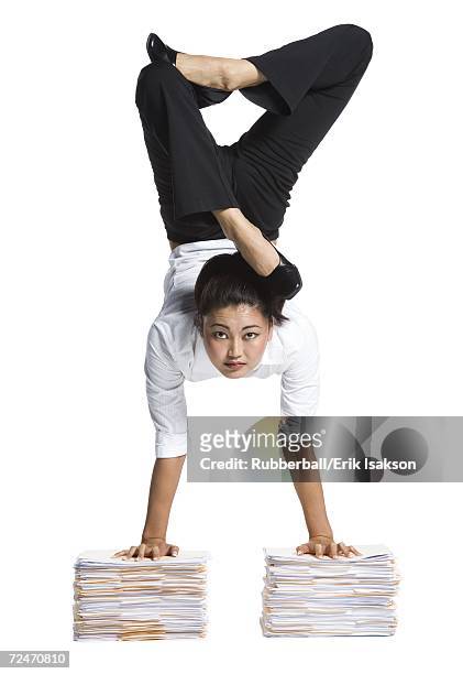 female contortionist businesswoman - businesswoman handstand stock-fotos und bilder