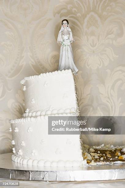 wedding cake visual metaphor with figurine cake toppers - exploding cake stock pictures, royalty-free photos & images