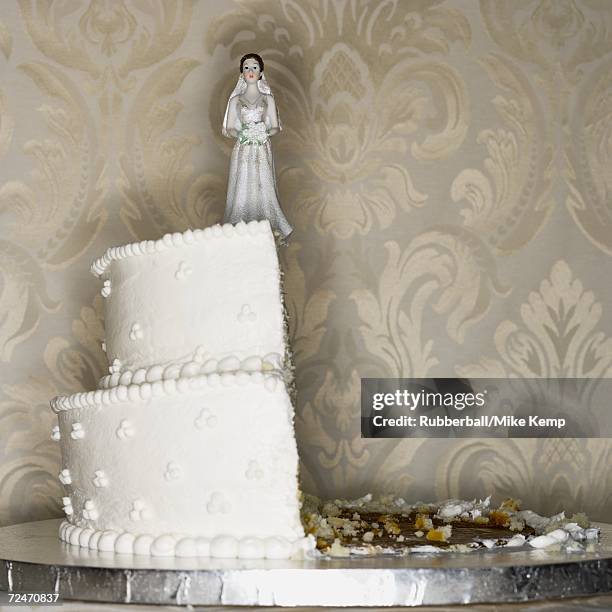 wedding cake visual metaphor with figurine cake toppers - exploding cake stock pictures, royalty-free photos & images