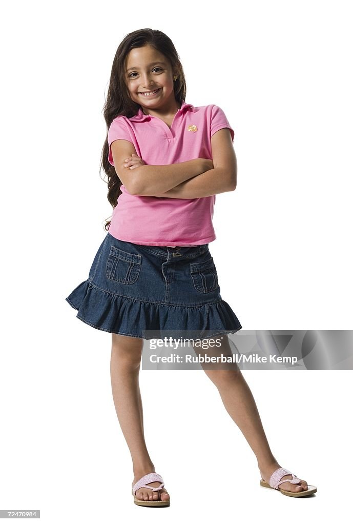 Portrait of a girl smiling with her arms crossed