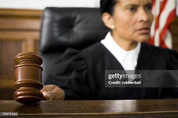 female judge holding a gavel - judge bench stock pictures, royalty-free photos & images