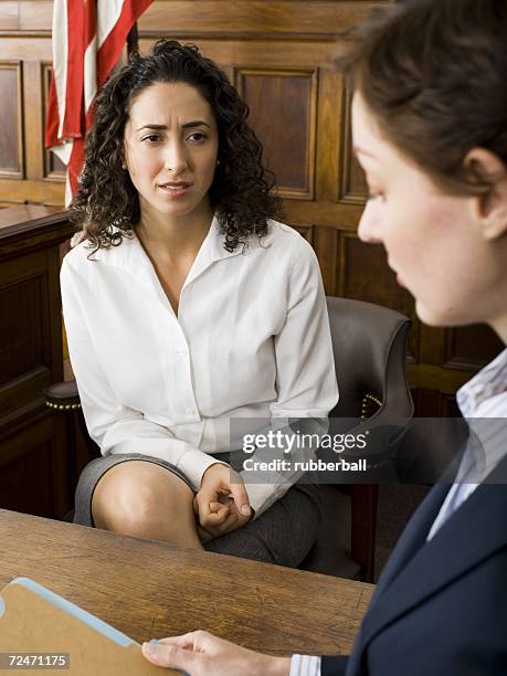 a female witness looking at a female lawyer - witness trial stock pictures, royalty-free photos & images