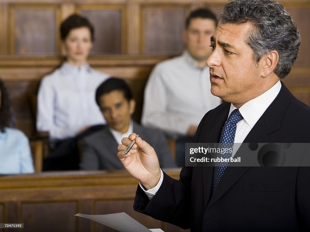 A male lawyer talking in a courtroom