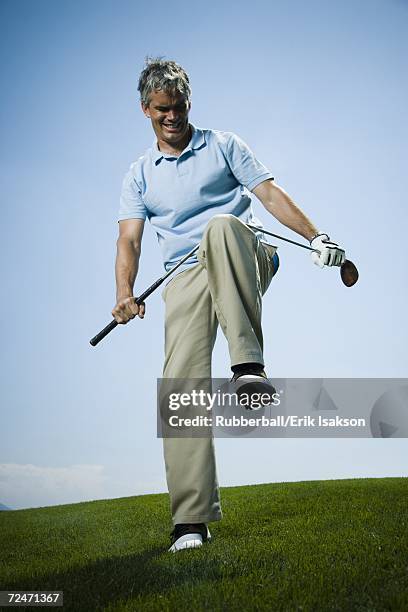 low angle view of a man breaking a golf club - broken golf club stock pictures, royalty-free photos & images