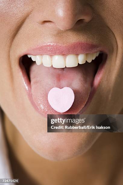 close-up of candy on a young woman's tongue - candy on tongue stock pictures, royalty-free photos & images