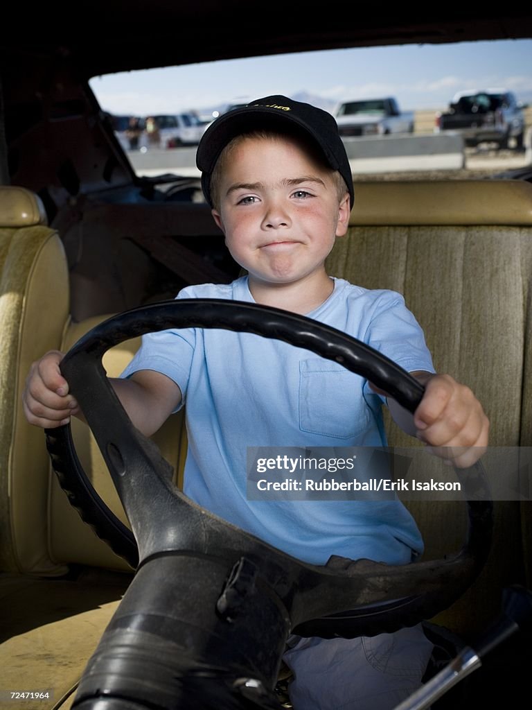 Young boy pretending to drive