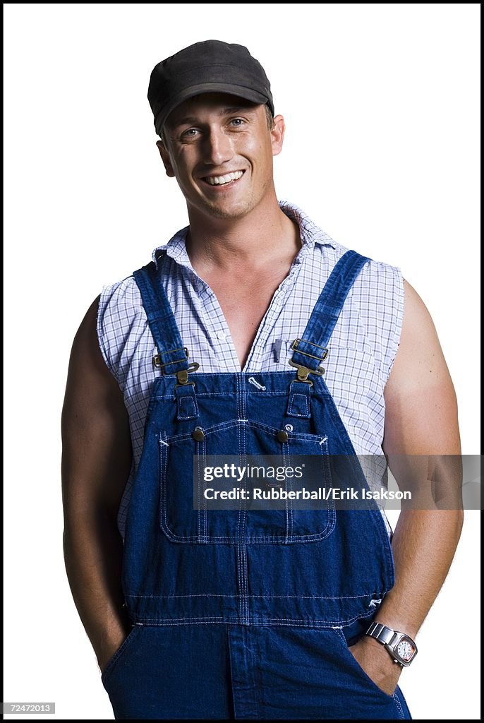 Farmer wearing a ball cap with hands in pockets