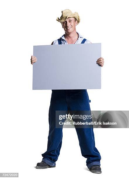 farmer wearing a straw hat holding a blank sign - hillbilly stock pictures, royalty-free photos & images