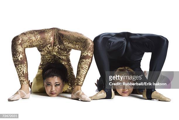 female contortionist duo performing - young contortionist stockfoto's en -beelden