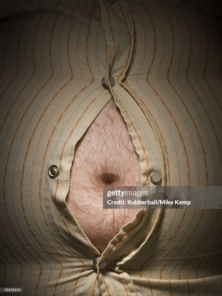 Close-up of fat stomach bursting through shirt