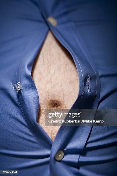 close-up of fat stomach bursting through shirt - male belly button stock pictures, royalty-free photos & images