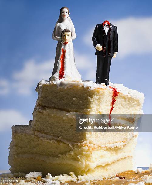 wedding cake visual metaphor with figurine cake toppers - wedding cake figurine stock-fotos und bilder