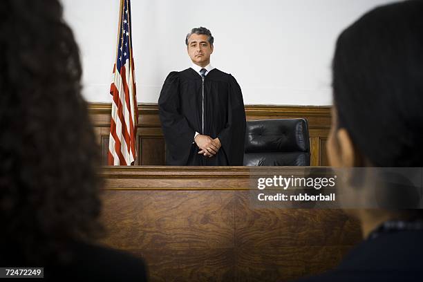 judge standing in front of defendants and lawyers - judge bench stock pictures, royalty-free photos & images