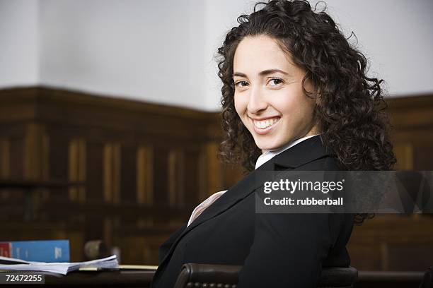 female lawyer smiling in courtroom - åklagare bildbanksfoton och bilder